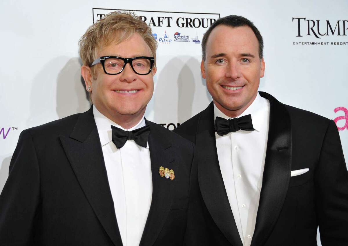 FILE - In this Oct. 18, 2010 file photo, Sir Elton John, left, and David Furnish attend the Ninth Annual Elton John AIDS Foundation benefit 'An Enduring Vision' at Cipriani Wall Street in New York. Elton John and David Furnish say they have become parents for a second time. The couple say they are "overwhelmed with happiness" at the birth of Elijah Joseph Daniel Furnish-John. John's spokeswoman Fran Curtis confirmed an announcement on the singer's website that the baby was born Friday Jan. 11, 2013 in Los Angeles to a surrogate mother, weighing 8 pounds, 4 ounces (3.7 kilograms). (AP Photo/Evan Agostini, File)