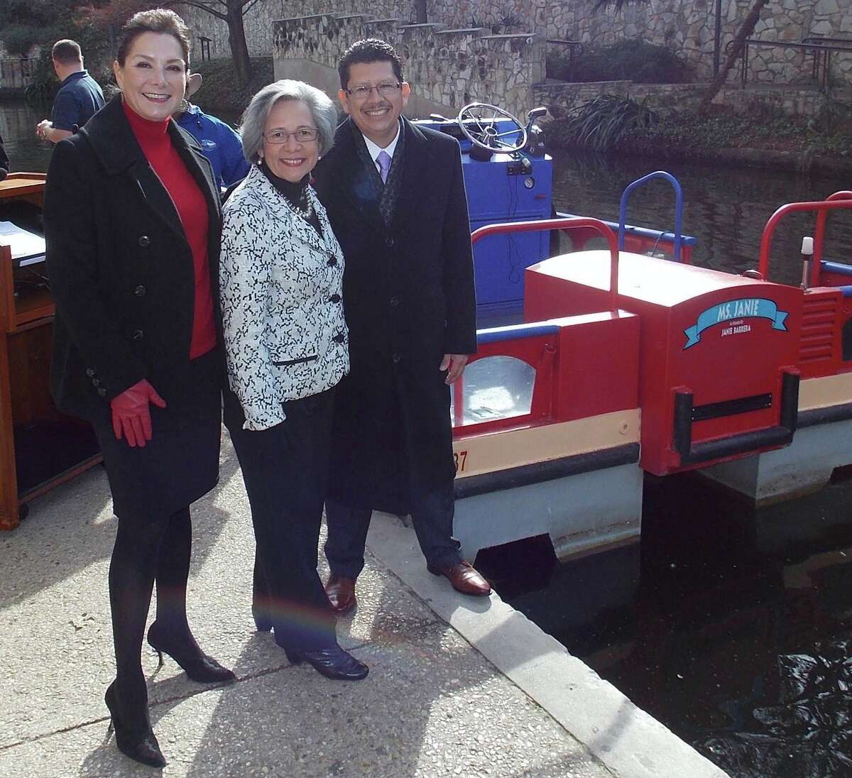 JoAnn Boone (from left), Janie Barerra and Richard Perez, president of the Greater San Antonio Chamber of Commerce, gather at the chamber's River Walk bank to christen the new barge, "The Ms. Janie."