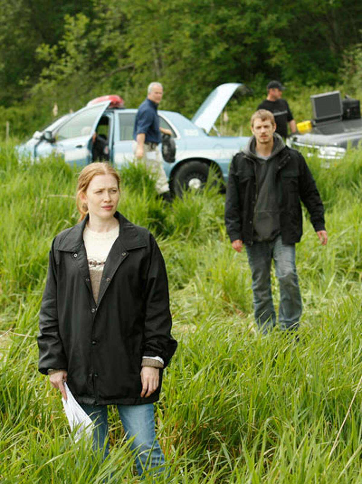 Not raining yet, but it will soon. Sarah Linden (Mireille Enos) and Stephen Holder (Joel Kinnaman) investigate the death of Rosie Larsen.