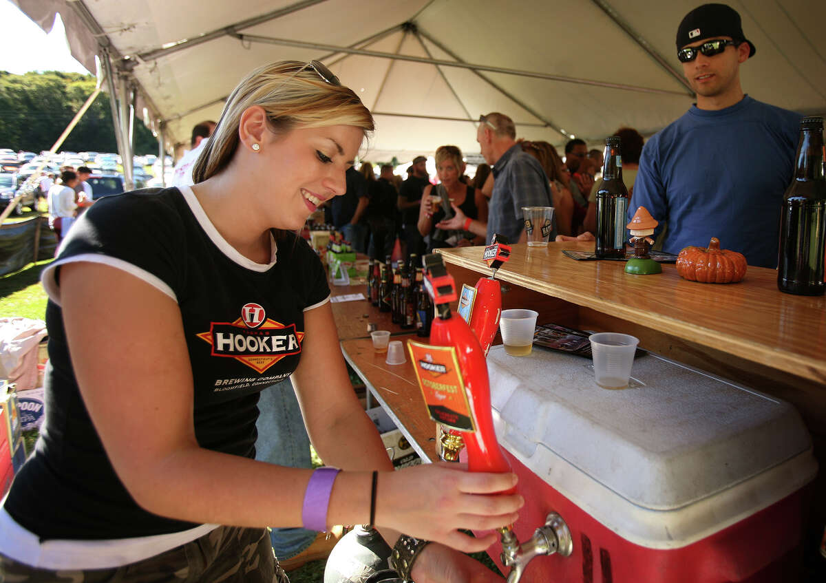 Kate Pasternak of Avon pours Oktoberfest beer from Bloomfield's Thomas Hooker Brewery at the first annual Hoptoberfest at Warsaw Park in Ansonia on Sunday, September 23, 2012. Thomas Hooker is one of many breweries open in Connecticut.