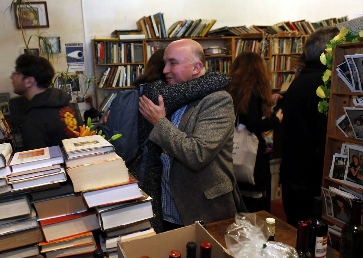 Andrew McKinley gets a hug from Kristina Kearns at Adobe Bookshop in San Francisco, Calif., on Wednesday, January 16, 2013. Adobe is going out of business, and three great SF writers -- Stephen Elliott, Rebecca Solnit and Michelle Tea -- participated in a reading in the store as a kind of farewell on Wednesday, January 16, 2013.