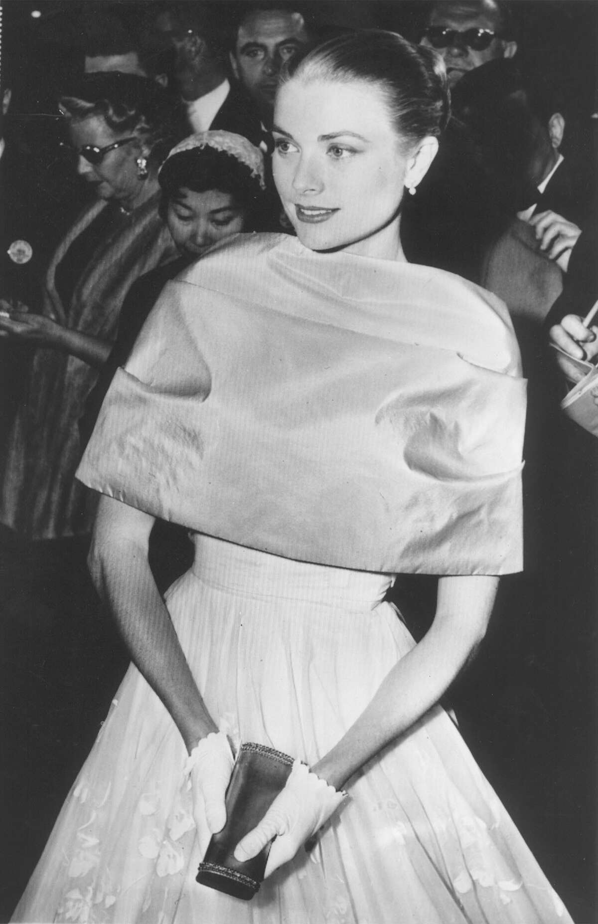 ** FOR USE WITH AP WEEKLY FEATURES ** Grace Kelly at Hollywood's Oscar ceremony - Grace Kelly, making what may be her final Hollywood appearance as a movie star, pauses in the lobby of Pantages Theater as she arrived tonight for the annual Academy Award presentations. As a winner of the previous year, she was to participate in the program as an award presenter. She leaves tomorrow for New York and Monaco and her April wedding to Prince Rainier of Monaco. (AP Photo/File)