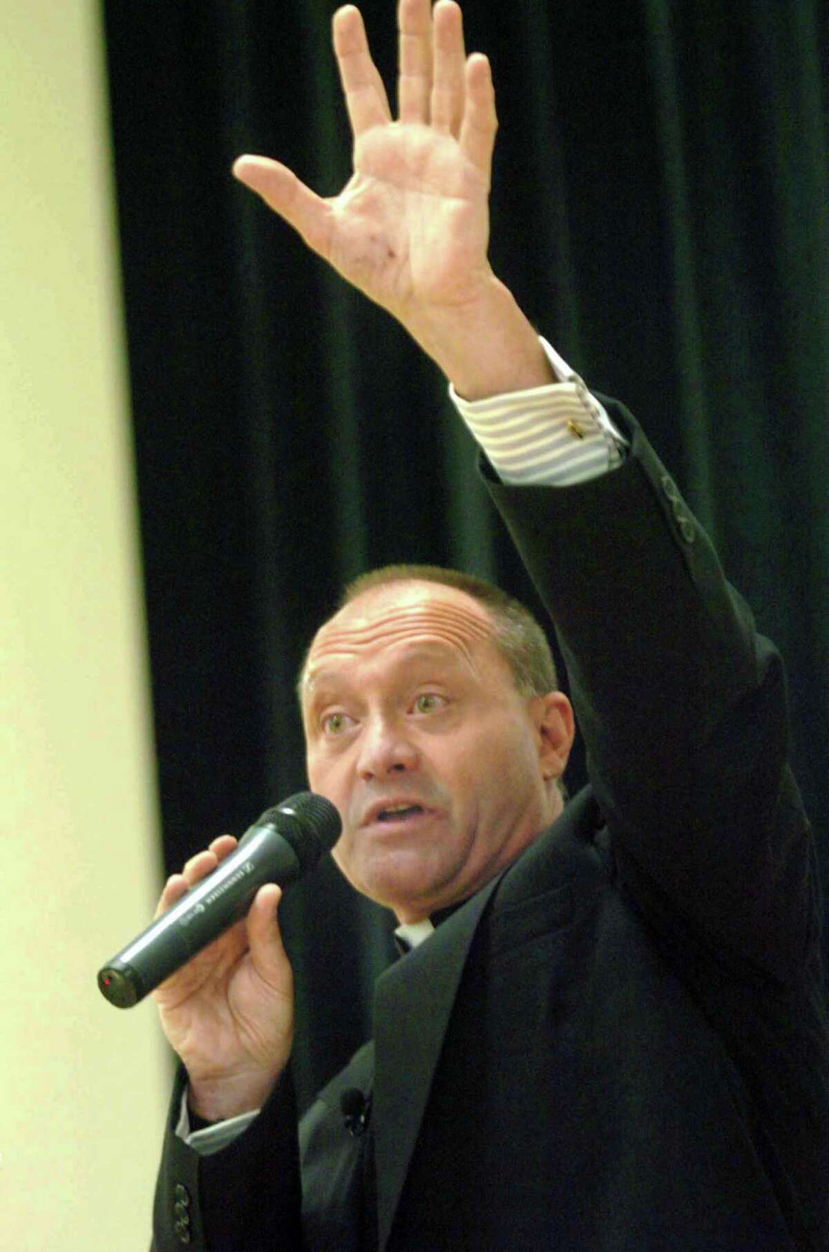 Monsignor Kevin Wallin addresses the faithful, a packed house, at the Cathloic Center on Jewett Avenue, in Bridgeport, Conn. May 4th, 2006.