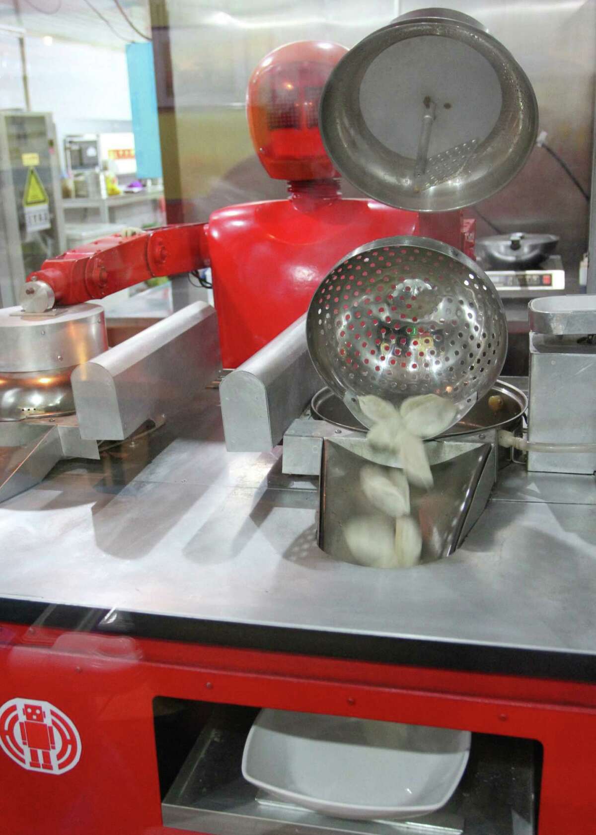 A robot cooks dumplings in the robot restaurant on Jan. 16, 2013.