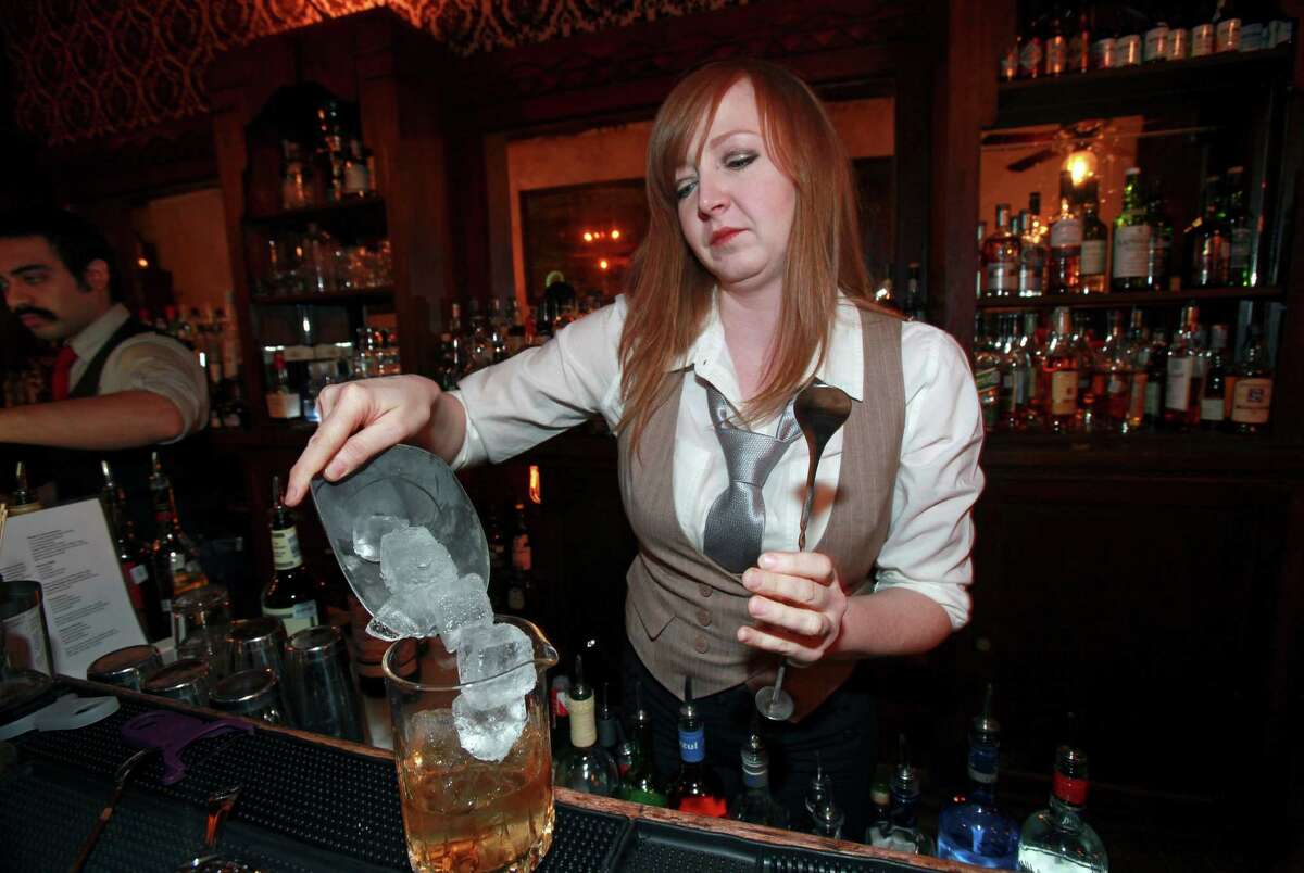 Bartender Liz Forsythe prepares a Perfect Manhatten drink as she works at the Esquire Tavern on January 15, 2013. She will