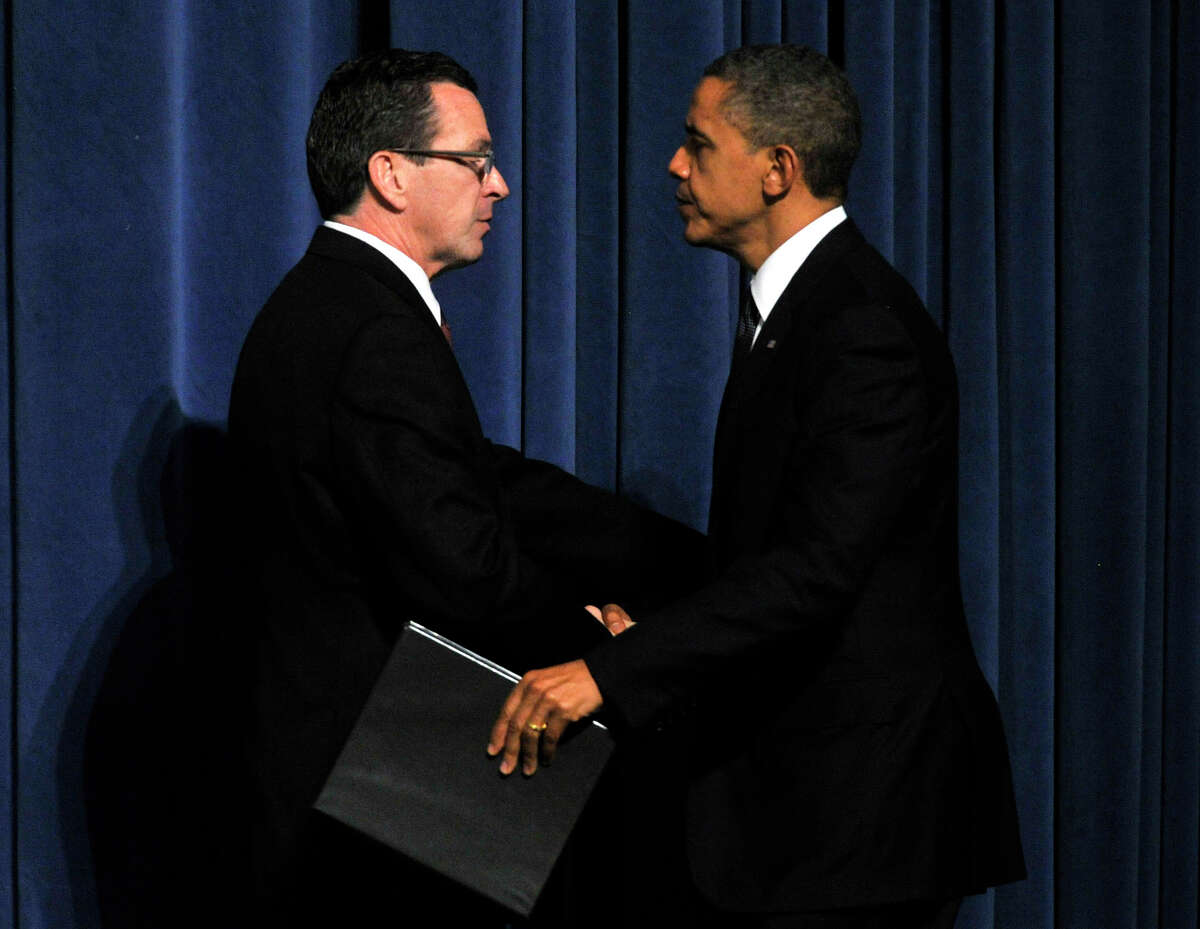 President Barack Obama greets Connecticut Gov. Dannel P. Malloy during an interfaith vigil for the families and residents affected by the Sandy Hook Elementary School shooting at Newtown High School in Newtown, Conn., on Sunday, Dec. 16, 2012.