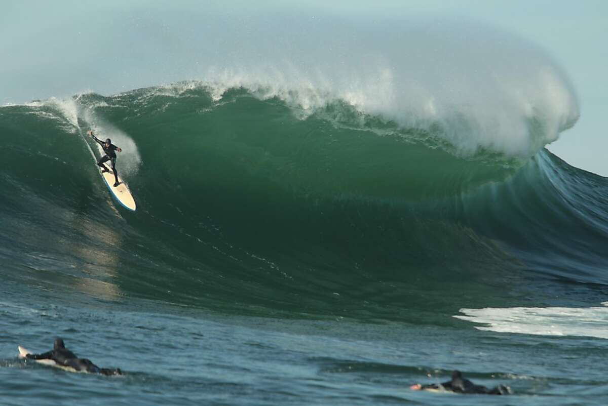 On the day before the Mavericks Invitational, a surfer rides a wave at the big wave spot on Saturday, January 19, 2013.