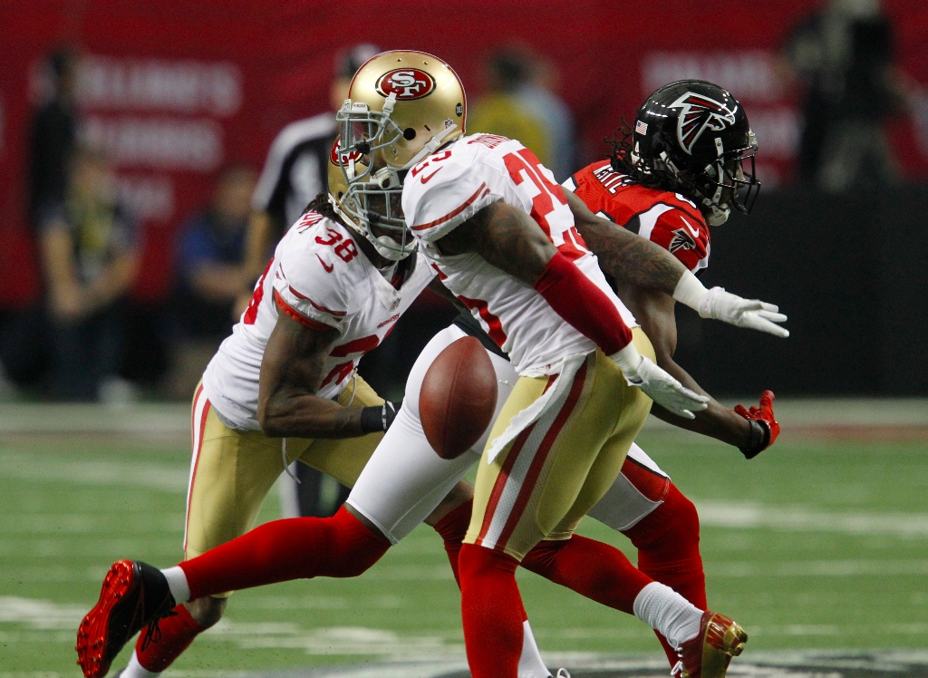 San Francisco 49ers Linebacker Aldon Smith (99), Defensive tackle Ray  McDonald (91), Linebacker NaVorro Bowman (53 and Offensive tackle Joe  Staley (74) pick up Atlanta Falcons running back Jacquizz Rodgers (32)  during