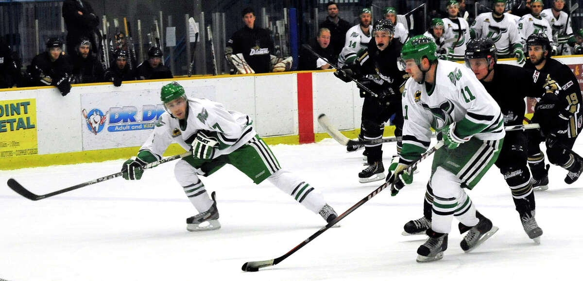 Danbury Whalers Alec Kirschner, left, and Phil Aucoin, right, move in to score the first Whalers goal against the Danville Dashers Sunday, Jan. 20, 2013 in Danbury.