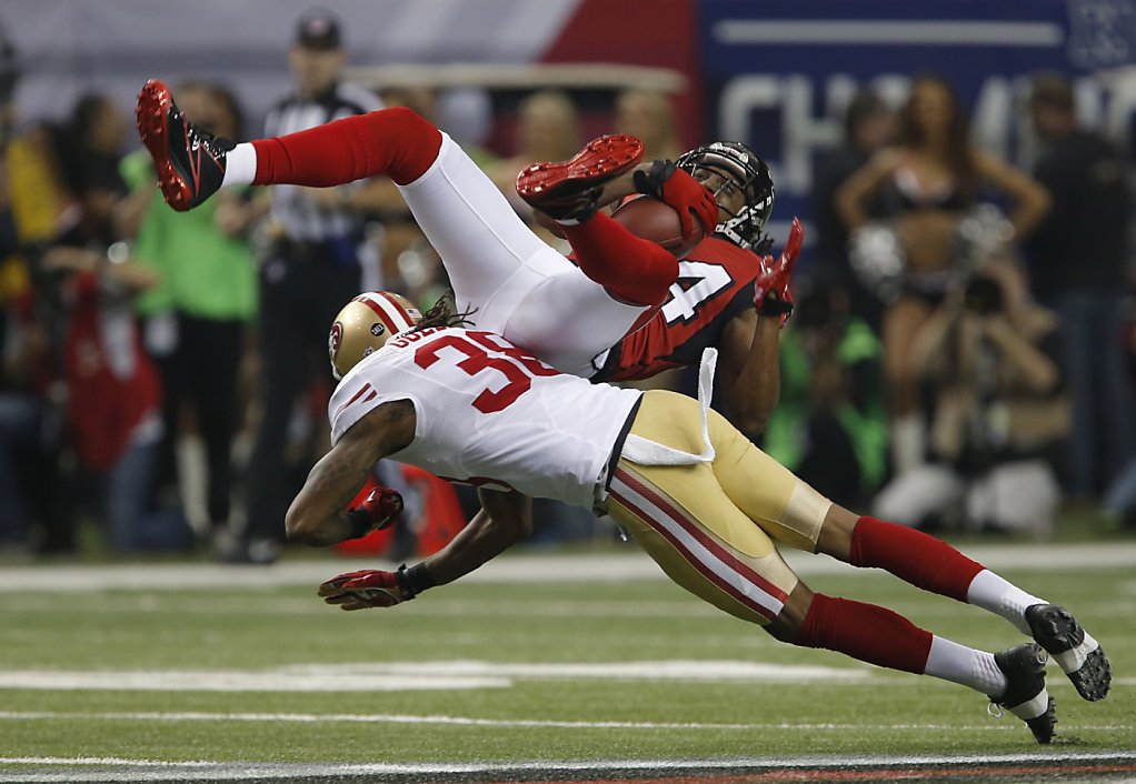 San Francisco 49ers Linebacker Aldon Smith (99), Defensive tackle Ray  McDonald (91), Linebacker NaVorro Bowman (53 and Offensive tackle Joe  Staley (74) pick up Atlanta Falcons running back Jacquizz Rodgers (32)  during