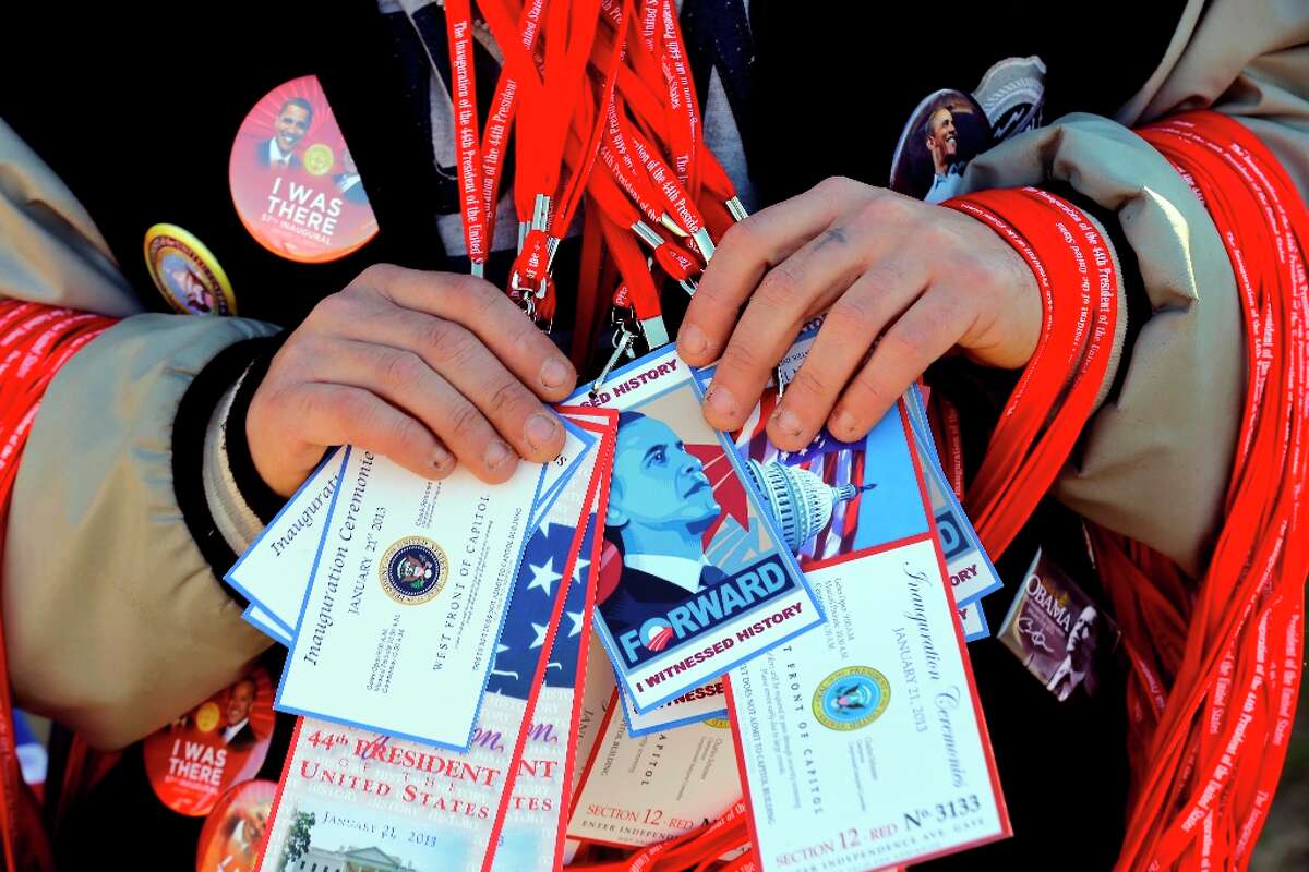 A vendor holds items for sale on the National Mall with the U.S. Capitol prepared for the ceremonial swearing-in of President Barack Obama, the 57th Presidential Inaugural, Sunday, Jan. 20, 2013 in Washington.