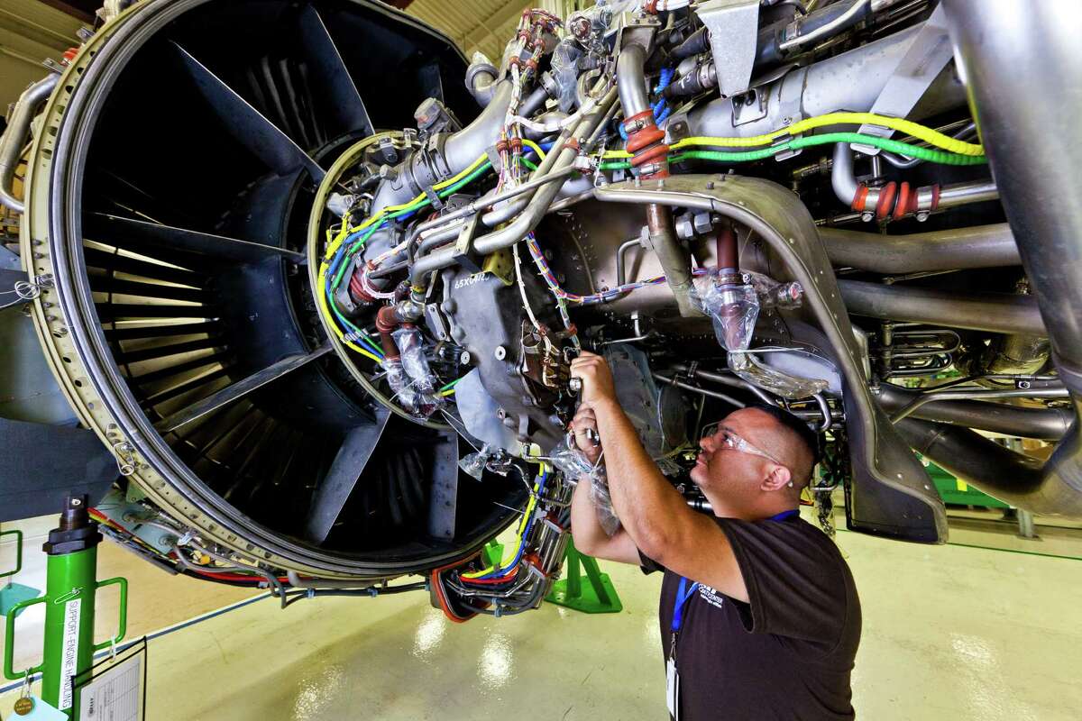 A worker at Port San Antonio's Kelly Aviation Center performs maintanence on a jet engine. Kelly Aviation's Lockheed Martin Corp. has purchased the assets of a similar Canadian facility and will rename it Kelly Aviation Center Montreal.