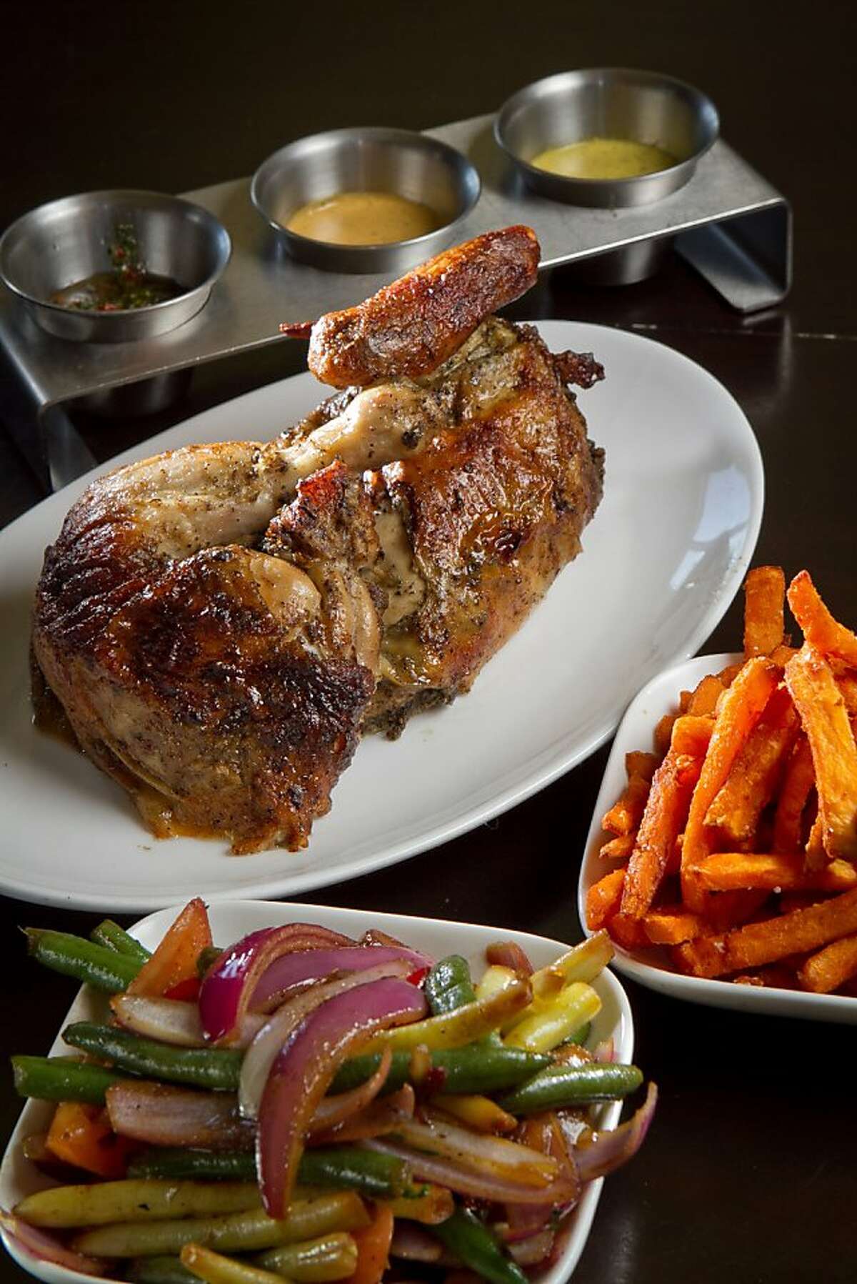 The Half Chicken with sides of Veggies and Sweet Potato Fries at Limon Rotisserie in San Francisco, Calif., is seen on Thursday, October 18th, 2012.