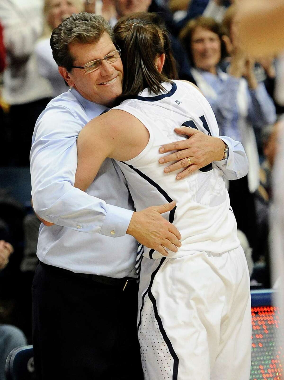 Connecticut coach Geno Auriemma, left, hugs Connecticut's Kelly Faris during the second half of an NCAA college basketball game in Storrs, Conn., Monday, Jan. 21, 2013. Faris had 18 points and 12 rebounds in Connecticut's 79-49 win over Duke. (AP Photo/Jessica Hill)