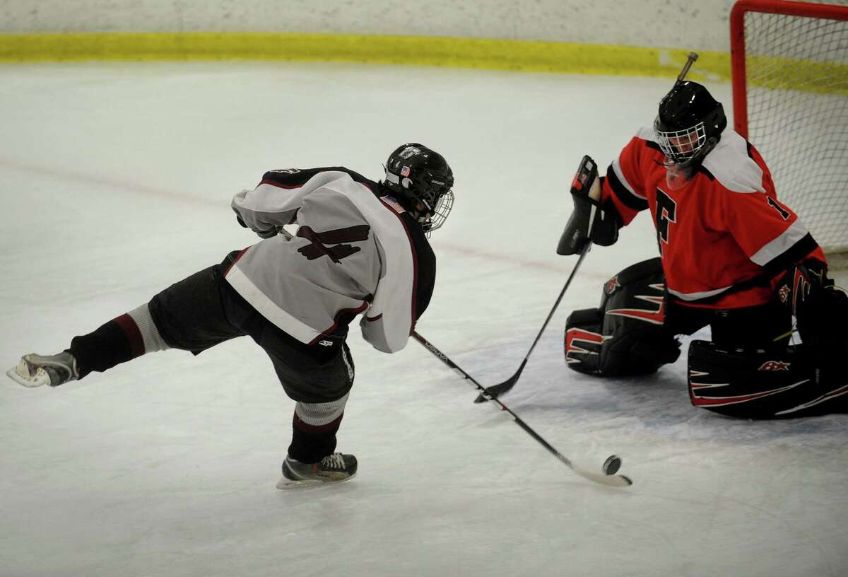 Milford's Robert Buskey is stopped on a breakaway shot by Fairfield goalie Connor Frawley during their boys hockey matchup at the Milford Ice Pavilion on Monday, January 21, 2013.