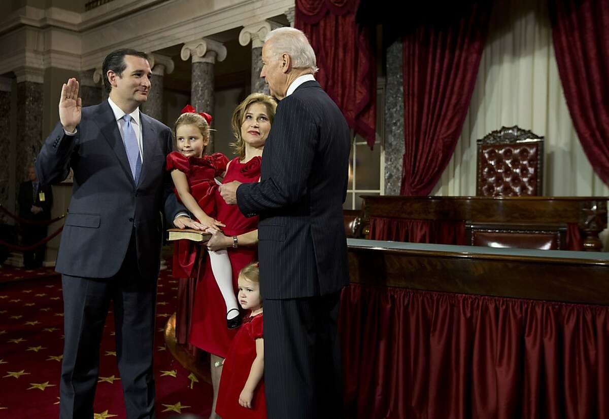 Vice President Joe Biden administers the Senate Oath to Sen. Ted Cruz, R-Texas, accompanied by his wife Heidi Nelson, and daughters Caroline and Catherine, right. during a mock swearing in ceremony on Capitol Hill in Washington, Thursday, Jan. 3, 2013, as the 113th Congress officially began. (AP Photo/ Evan Vucci)