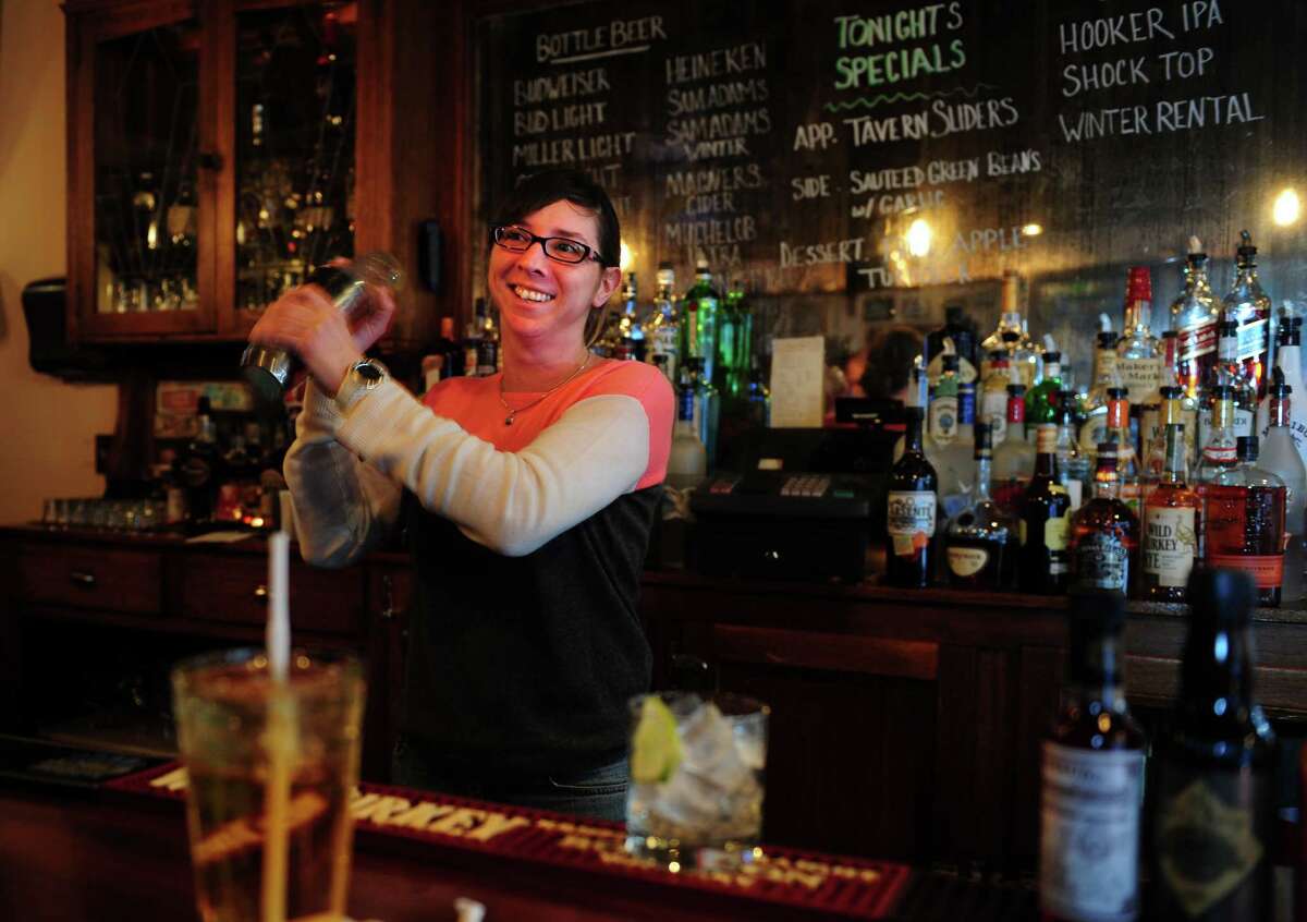 Emilie Robinson, part-owner and bar manager, mixes up a margarita at Tautog Tavern, a New England-style pub in the Black Rock section of Bridgeport, Conn.