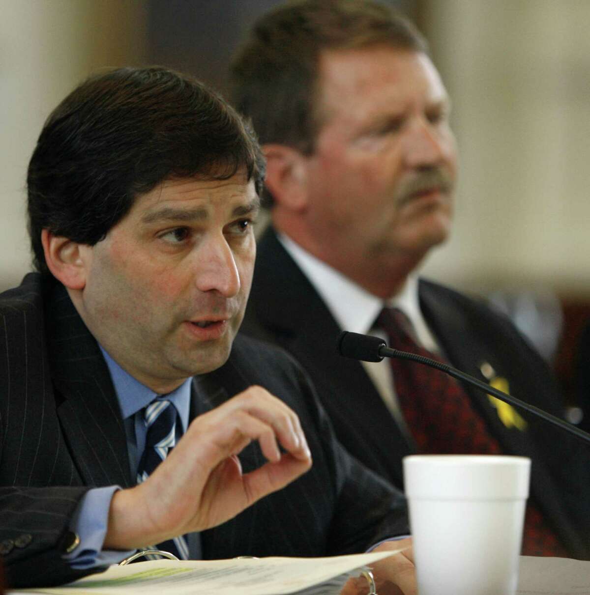 Sen. Kevin Eltife, R-Tyler, left, questions Albert Hawkins, Texas' Health and Human Services commissioner, during a meeting of the Senate Nominations Committee Wednesday, Feb. 28, 2007, in Austin, Texas. Sen. Mike Jackson, R-League City, right, chairs the committee. The committee left pending Hawkins' renomination to the post. (AP Photo/Harry Cabluck)
