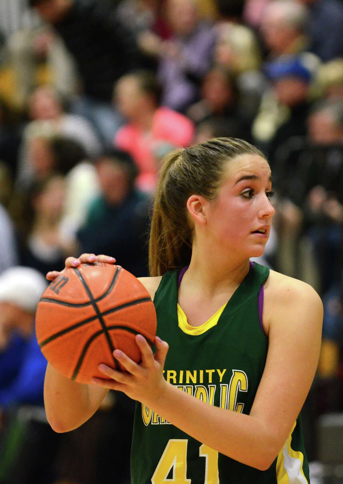 Trinity Catholic's Anne Margaret Eilertsen (41) controls the ball during the girls basketball game against Darien at Darien High School on Tuesday, Jan. 22, 2013.