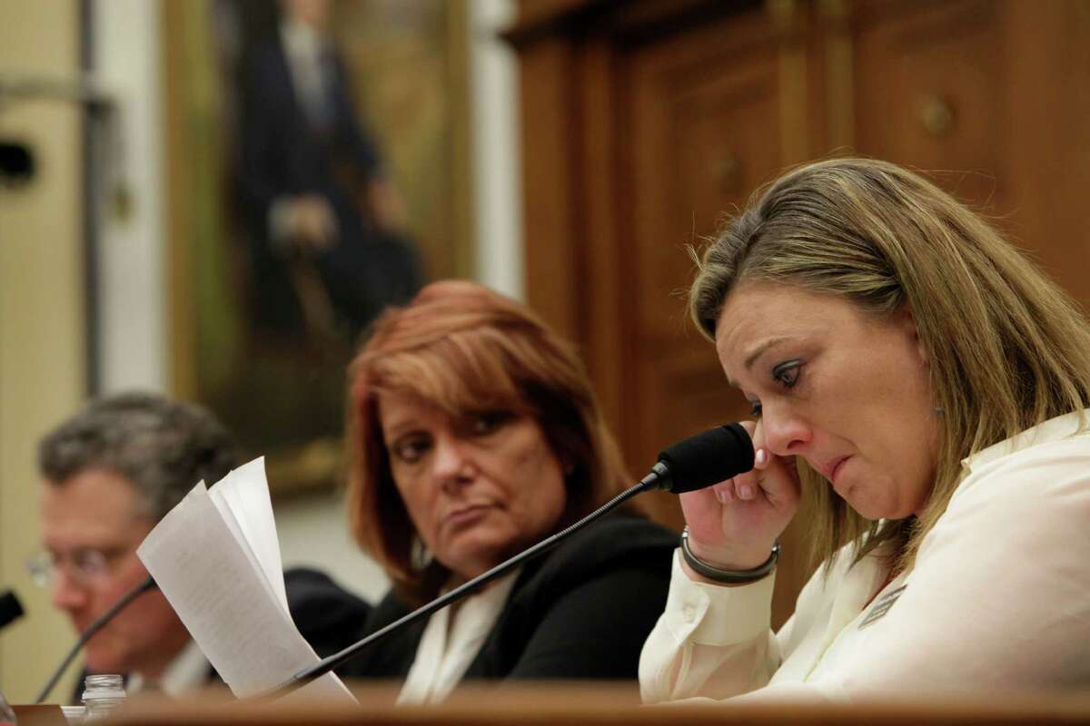 WASHINGTON, DC - January 23 - Technical Sergeant Jennifer Norris, USAF, (ret) wipes a tear as she testifies at a review of sexual misconduct by basic training instructors at Lackland Air Force Base by House Armed Services Committee, 2118 Rayburn Building. At left are witnesses David Lisak, PH.D., forensic Consultant and Chief Master Sergeant Cindy McNally, USAF(ret)