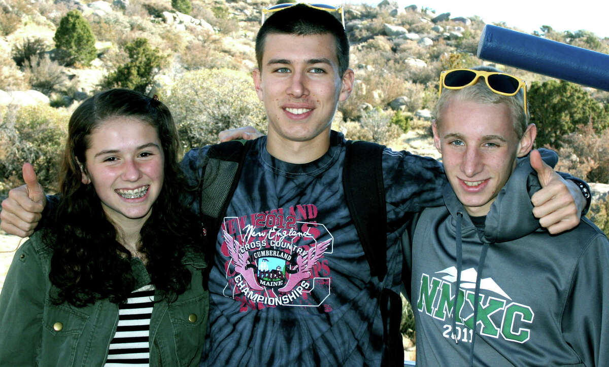 Emily Day, Ryan Clarke, center, and John Hansell of New Milford High School pose for a keepsake photo during their December, 2012 stay in New Mexico for the national Junior Olympics cross country competition. Courtesy of Audrey Day