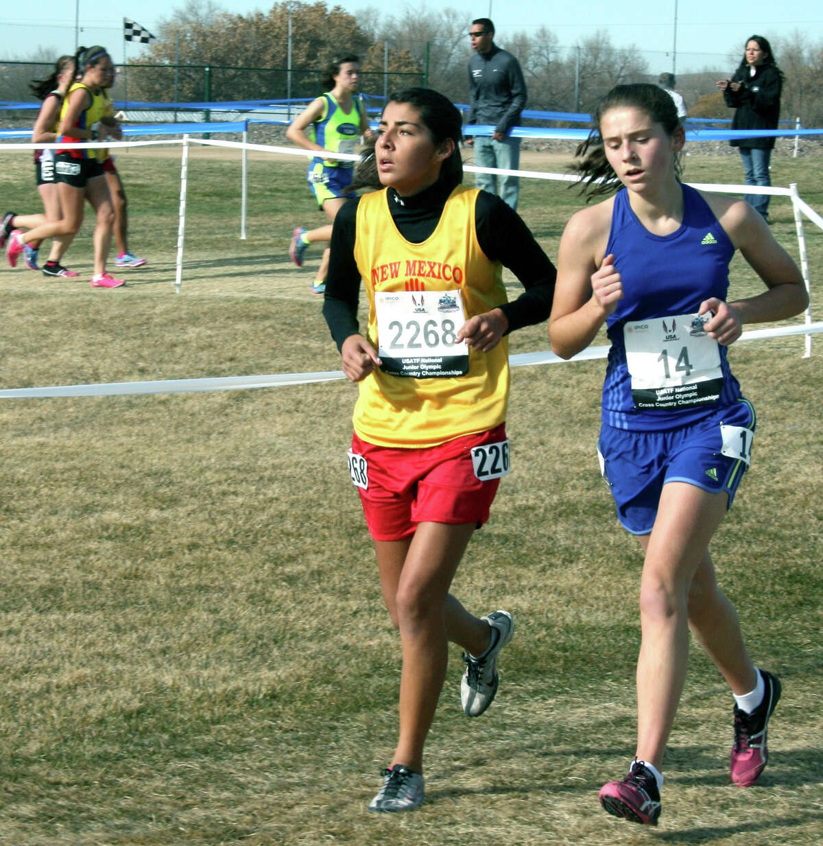 Emily Day, right, of New Milford High School keeps pace with a rival while running in December, 2012 in New Mexico in the national Junior Olympics cross country competition. Courtesy of Audrey Day