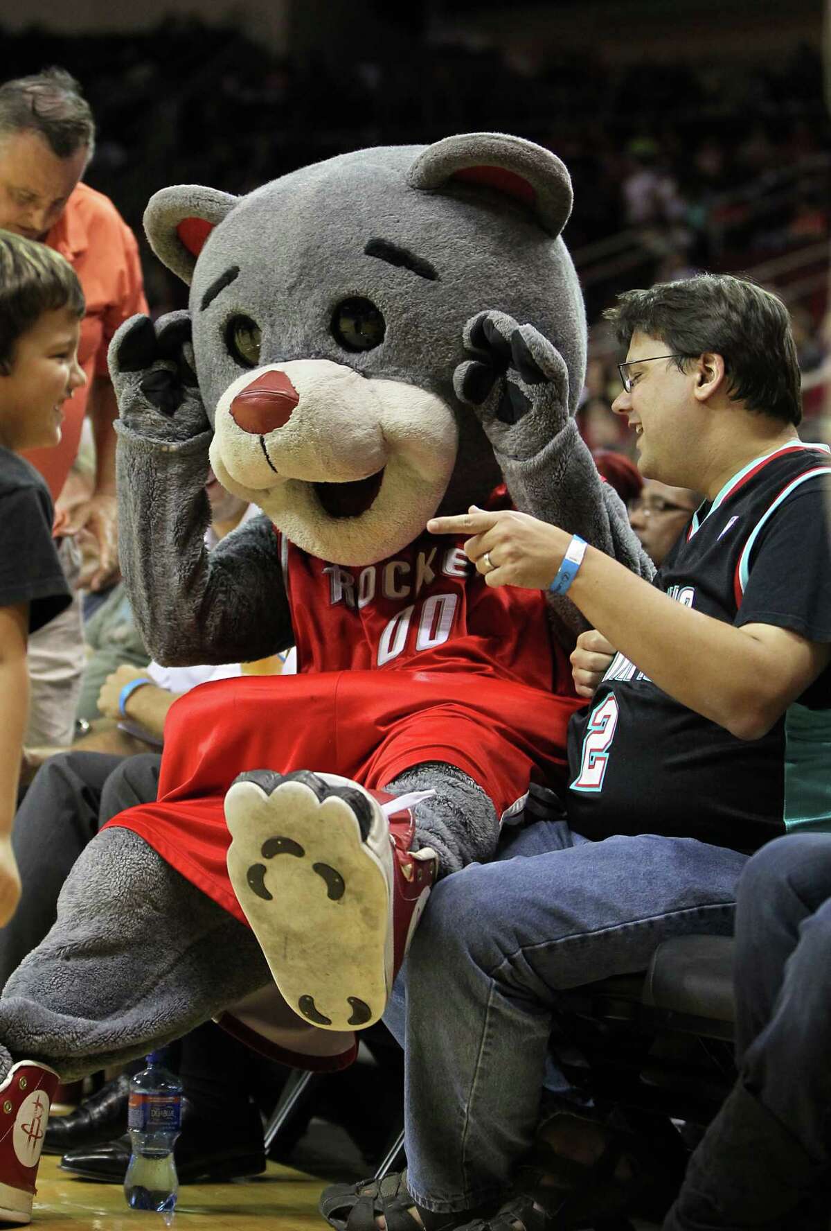 Clutch the Bear jokes around with fans at a Rockets game.