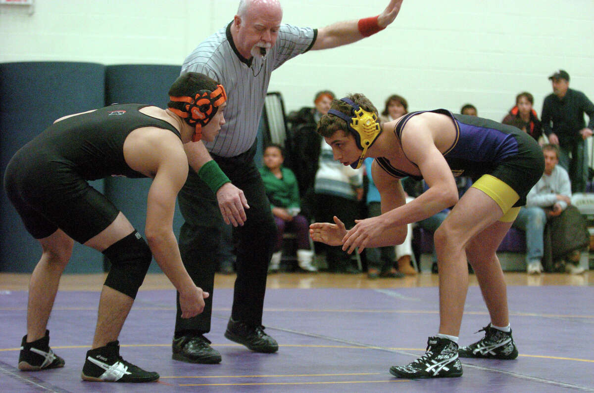 Westhill's Chris Mazur, right, and Stamford's Christian Llanos wrestle in the 138 pound weight class as Westhill hosts Stamford High School in a wrestling match in Stamford, Conn., Jan. 23, 2013.