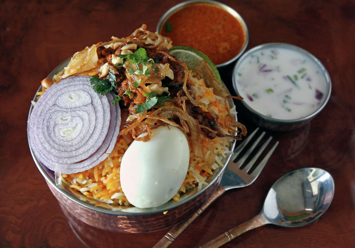 Kheema Biryani is a stew served atop fragrant basmati rice with a pair of sauces.
