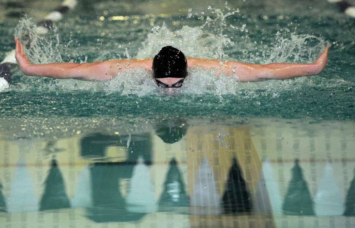 Westhill-Stamford's Oscar Ike competes in the 100 meter butterfly race during their meet with Staples High School Wednesday, Jan. 23, 2013 in Westport, Conn.