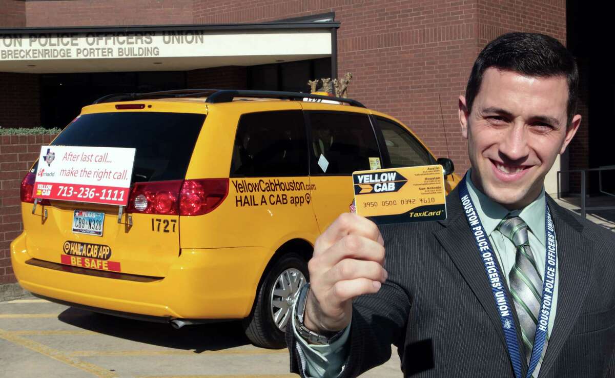 Houston Police Officers' Union Vice President Joseph Gamaldi holds a prepaid TaxiCard, part of a program that will have the union paying for cab rides home for police officers who have had too much too drink.