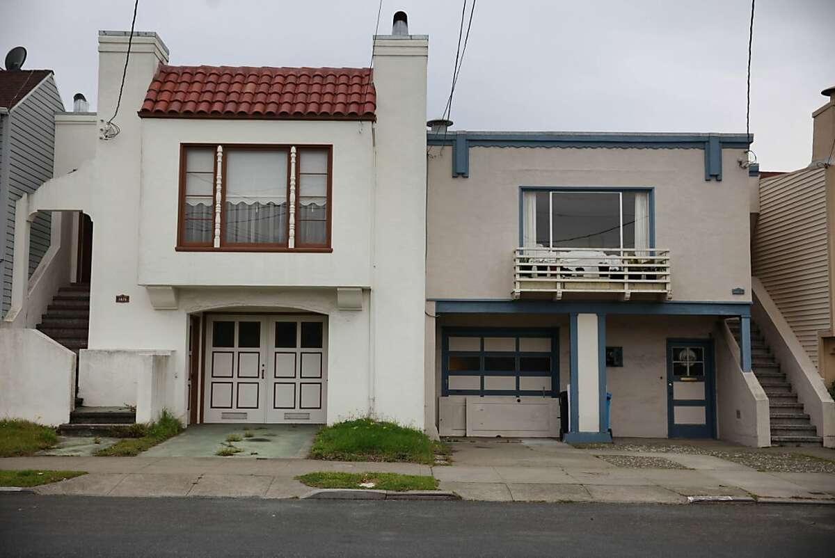 A home without its front yard paved over is seen next to a home with its front yard paved over in the Outer Sunset along 29th Avenue.