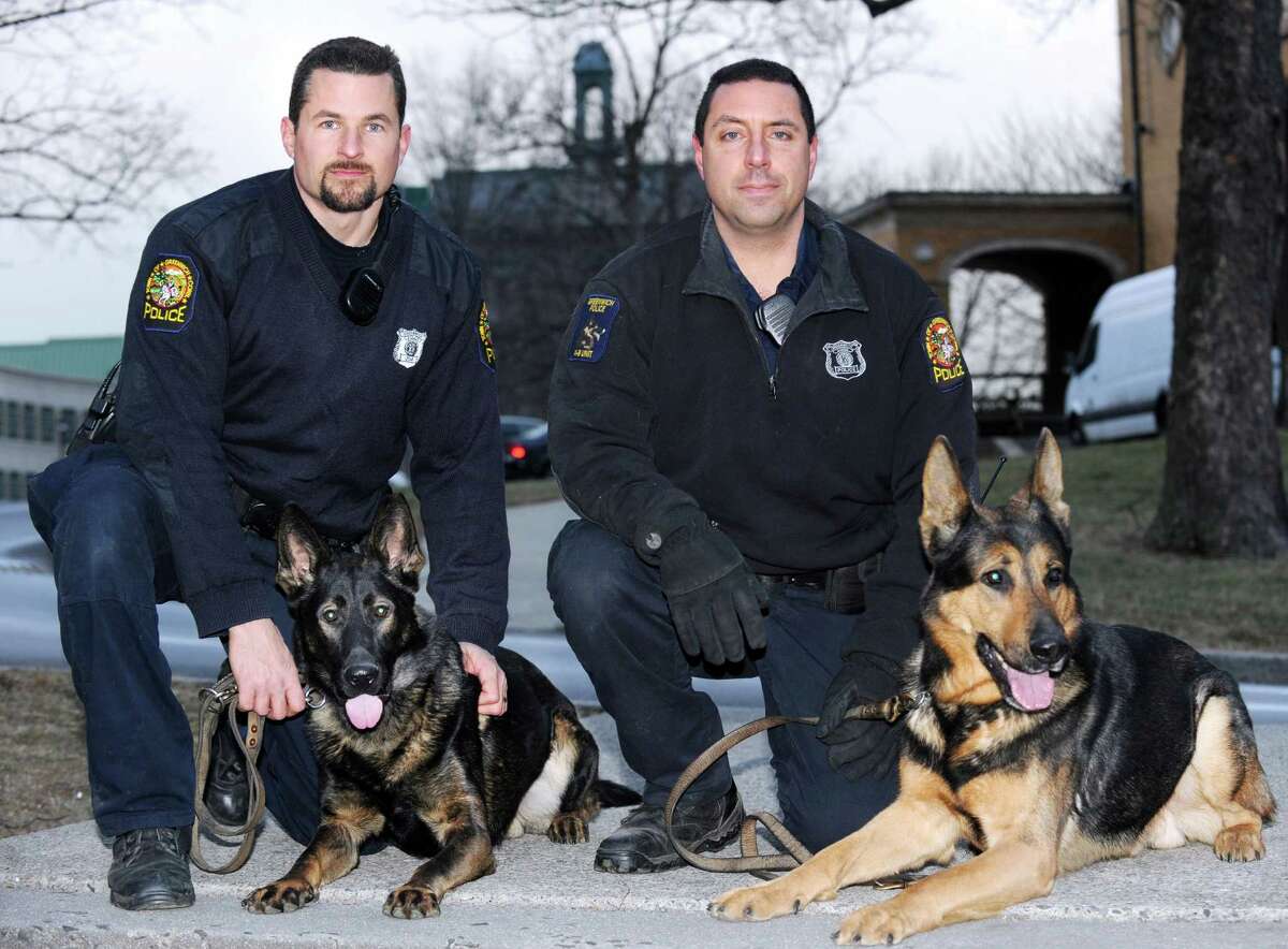 Greenwich Police K-9 Unit Officers Robert Smurlo, left, with his police dog, Altos, a German shepherd, and Mike Macchia and his police dog, Tyro, also a German shepherd, at Havemeyer Field in Greenwich, Friday afternoon, Jan. 25, 2013.