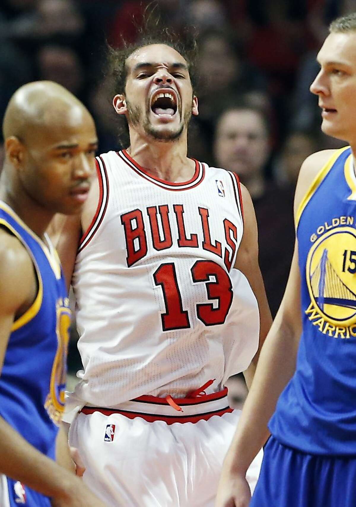 Chicago Bulls center Joakim Noah, center, reacts after Golden State Warriors' player fouled during the first half of an NBA basketball game in Chicago on Friday, Jan. 25, 2013. (AP Photo/Nam Y. Huh)