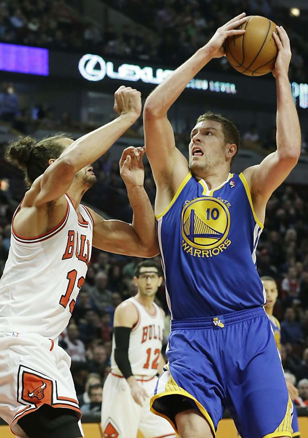 Golden State Warriors forward David Lee, right, looks to the basket against Chicago Bulls center Joakim Noah during the first half of an NBA basketball game in Chicago on Friday, Jan. 25, 2013. (AP Photo/Nam Y. Huh)
