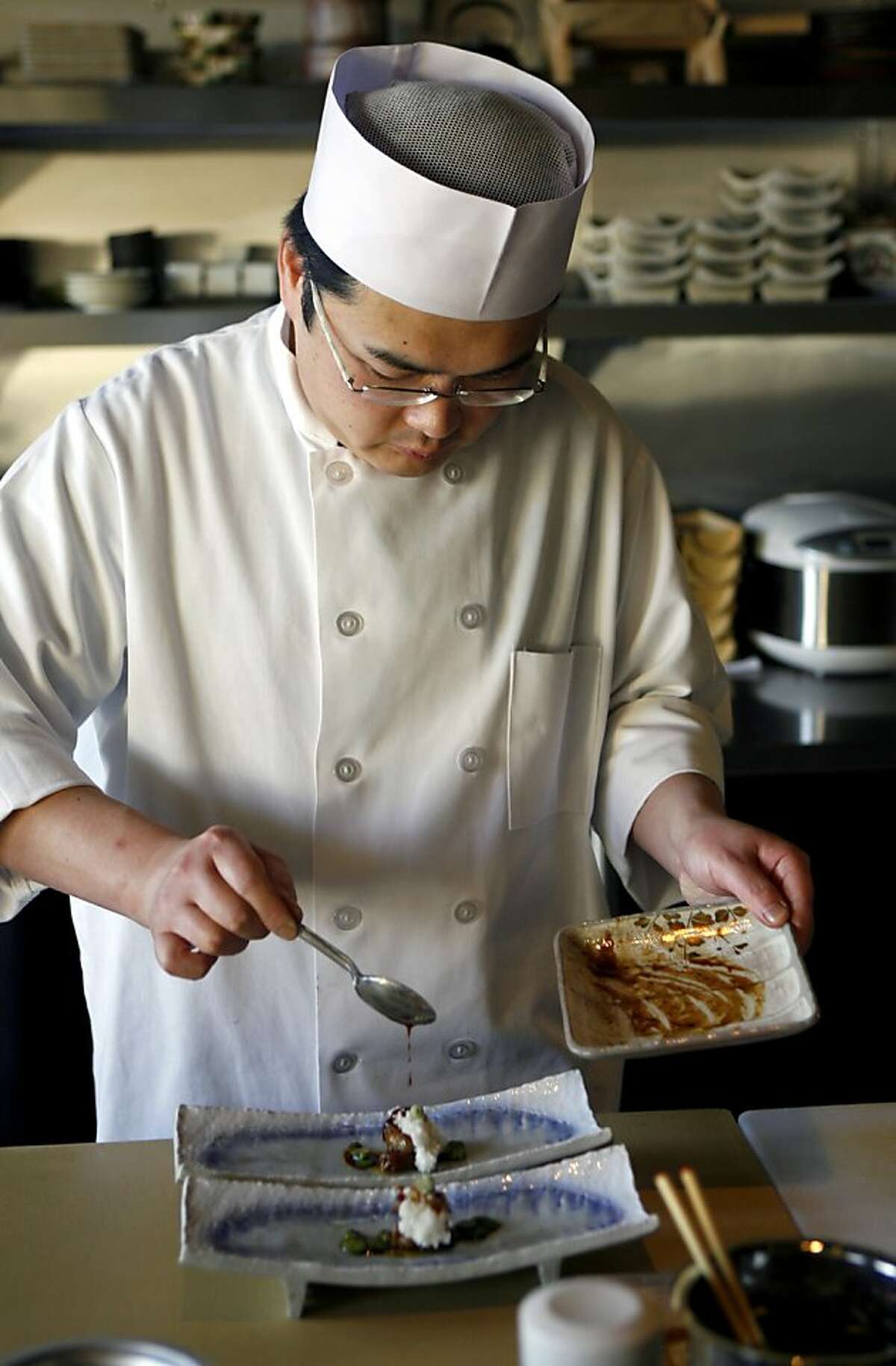 New caption:Chef and co-owner Katsuhiro Yamasaki prepares a dish at Wakuriya, a Japanese kaiseki restaurant, in San Mateo, Calif., on Thursday, May 7, 2009. Original caption: Chef and co-owner Katsuhiro Yamasaki adds the finishing touches to a foie gras dish at Wakuriya, a Japanese kaiseki restaurant, in San Mateo, Calif., on Thursday, May 7, 2009.