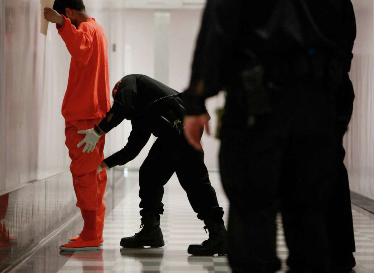 An inmate is patted down before entering the Five Keys Charter School at San Francisco County Jail No. 5 in San Bruno.