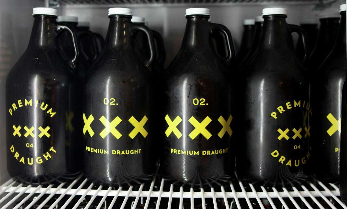 Chilled growler jugs are shown at Premium Draught in the 700 block of Studewood Friday, Jan. 25, 2013, in Houston. Premium Draught sells a variety of beers on tap in growlers, a large bottle that customer's pay an one-time deposit and then can refill the bottle for home consumption, along with bottle beer and other supplies. ( Brett Coomer / Houston Chronicle )