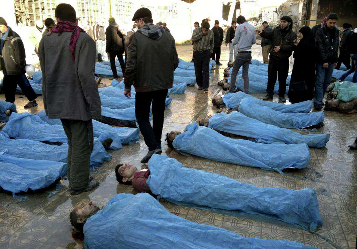 This citizen journalism image provided by Aleppo Revolution Against Assad's Regime which has been authenticated based on its contents and other AP reporting, shows dead bodies on a street in Aleppo, Syria Tuesday, Jan. 29, 2013. Syrian activists say at least 65 bodies, some of them with their hands tied behind their back, found on a river bank in the northern city of Aleppo. (AP Photo/Aleppo Revolution Against Assad Regime)