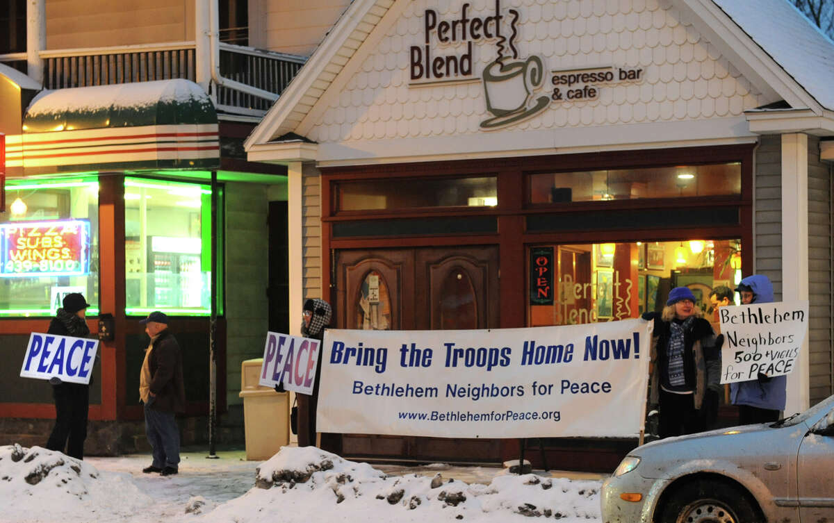 Bethlehem Neighbors participate in a vigil that commemorates over 500 peace vigils held at the Four Corner since 2003 on Monday Jan. 28, 2013 in Delmar, N.Y. (Lori Van Buren / Times Union)