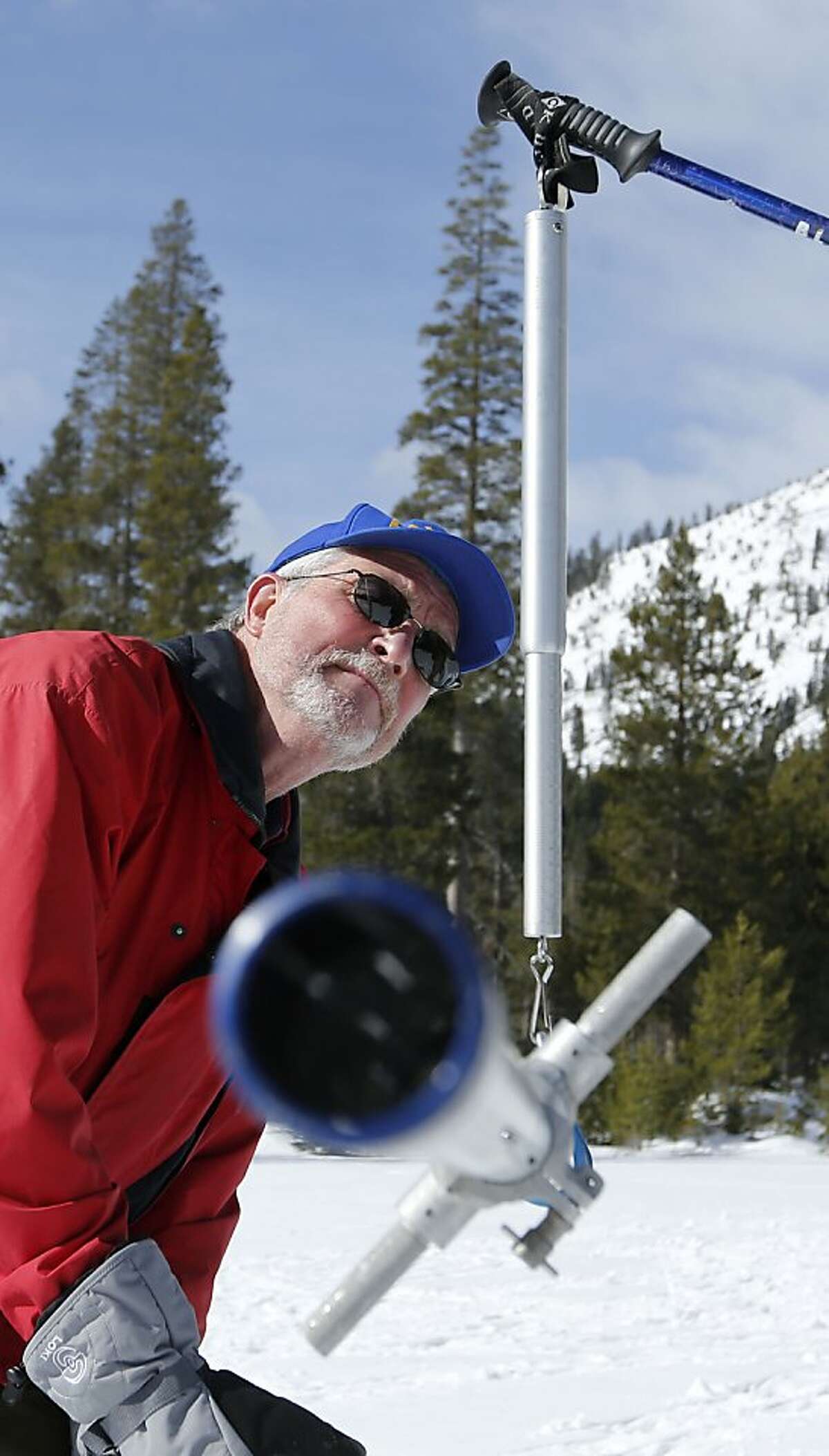 Frank Gehrke, chief of snow surveys for the Department of Water Resources, checks the weight of the snowpack survey tube as he conducts the second snow survey of the year at Echo Summit, Calif., Tuesday, Jan. 29, 2013. Surveyors have confirmed what many feared after a relatively dry January — the water content of snow that has accumulated in the Sierra is slightly below average for this time of year. (AP Photo/Rich Pedroncelli)