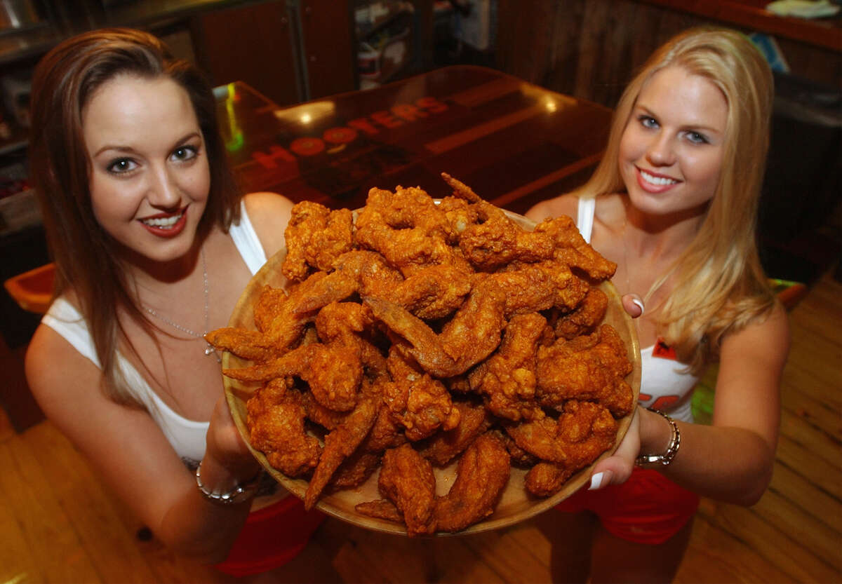 Hooters girls Shannon Kischefsky (left) and Casey Gandy hold a plate of Buffalo Wings that won the Readers Choice Award Friday May 17, 2002 at the restaurant on the Riverwalk.