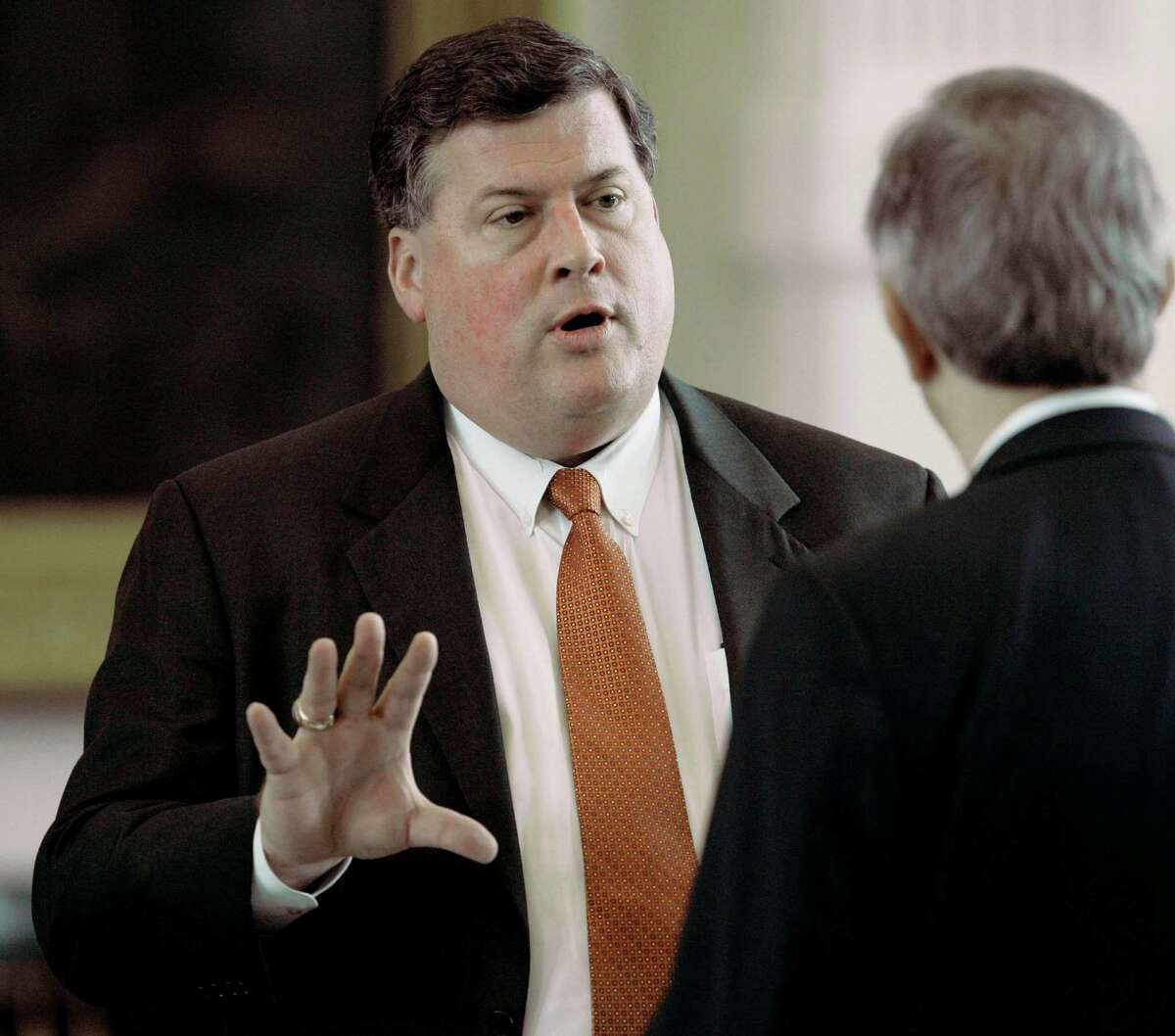 Sen. Tommy Williams, R-The Woodlands, left, talks with Sen. Jeff Wentworth, R-San Antonio, right, during the afternoon session in the Texas Senate Monday, May 14, 2007, in Austin, Texas. Hoping to avoid a veto override fight and a special legislative session, the Texas Senate began discussion on Williams' proposal that aims to address the governor's concerns with a sweeping transportation bill.