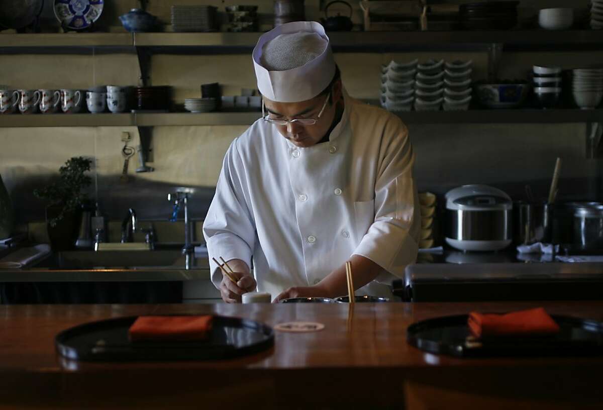 Chef and co-owner Katsuhiro Yamasaki adds the finishing touches on a dish at Wakuriya, a Japanese kaiseki restaurant, in San Mateo.