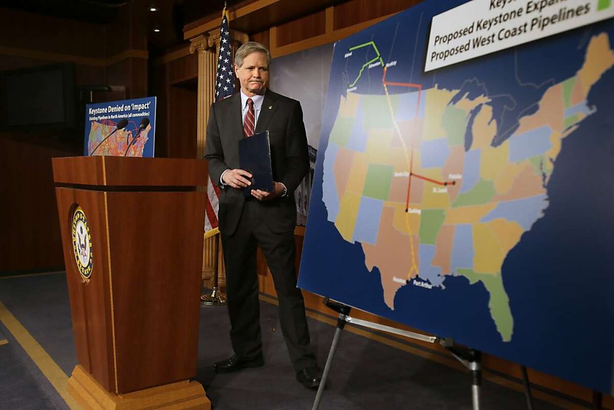 Sen. John Hoeven, R-N.D, walks toward a illustration of the Keystone Pipeline and proposed expansions, after a news conference on Capitol Hill in Washington, Wednesday, Jan. 23, 2013. A key approval of a revised route for the Keystone XL oil pipeline from Canada to the U.S. Gulf Coast puts the long-delayed project back in the hands of the U.S. government. (AP Photo/Jacquelyn Martin)