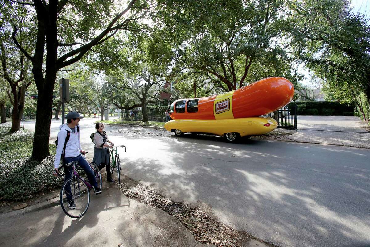 Lesley Yu and Joshua Leckie, from Houston, stop to admire the Oscar Mayer Weinermobile that was parked in front of the Make A Wish Foundation in Houston.