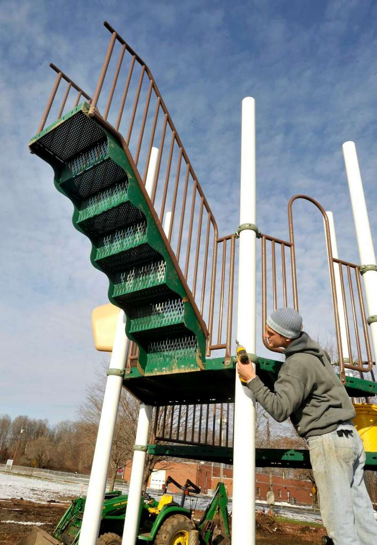 Anthony Sandagata, of Creative Recreation, works tighting components on the new Creative Playground system, in New Milford, on Monday, Dec.14,2009.