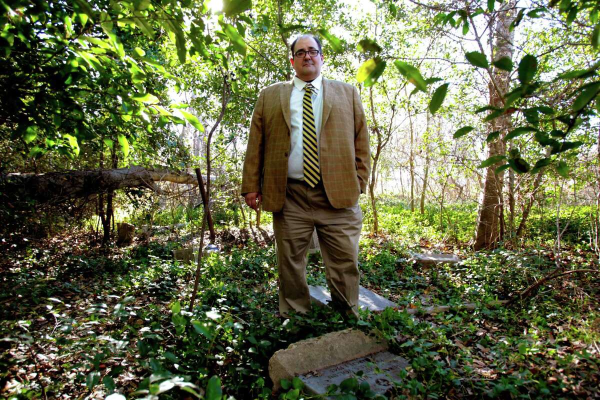 Doug Price, is the executive director of the Brenham Heritage Museum stands at the Camp Town Cemetery,covered up with overgrown brush, Thursday, January 31, 2013. The Cemetery is associated with the Mount Rose Missionary Baptist Church. It is one of two historically black cemeteries in or near Brenham, and the oldest known grave dates to 1840. It was last used for a burial in the early 2000s, although it is not routinely used for modern burials. (Billy Smith II/ Houston Chronicle)