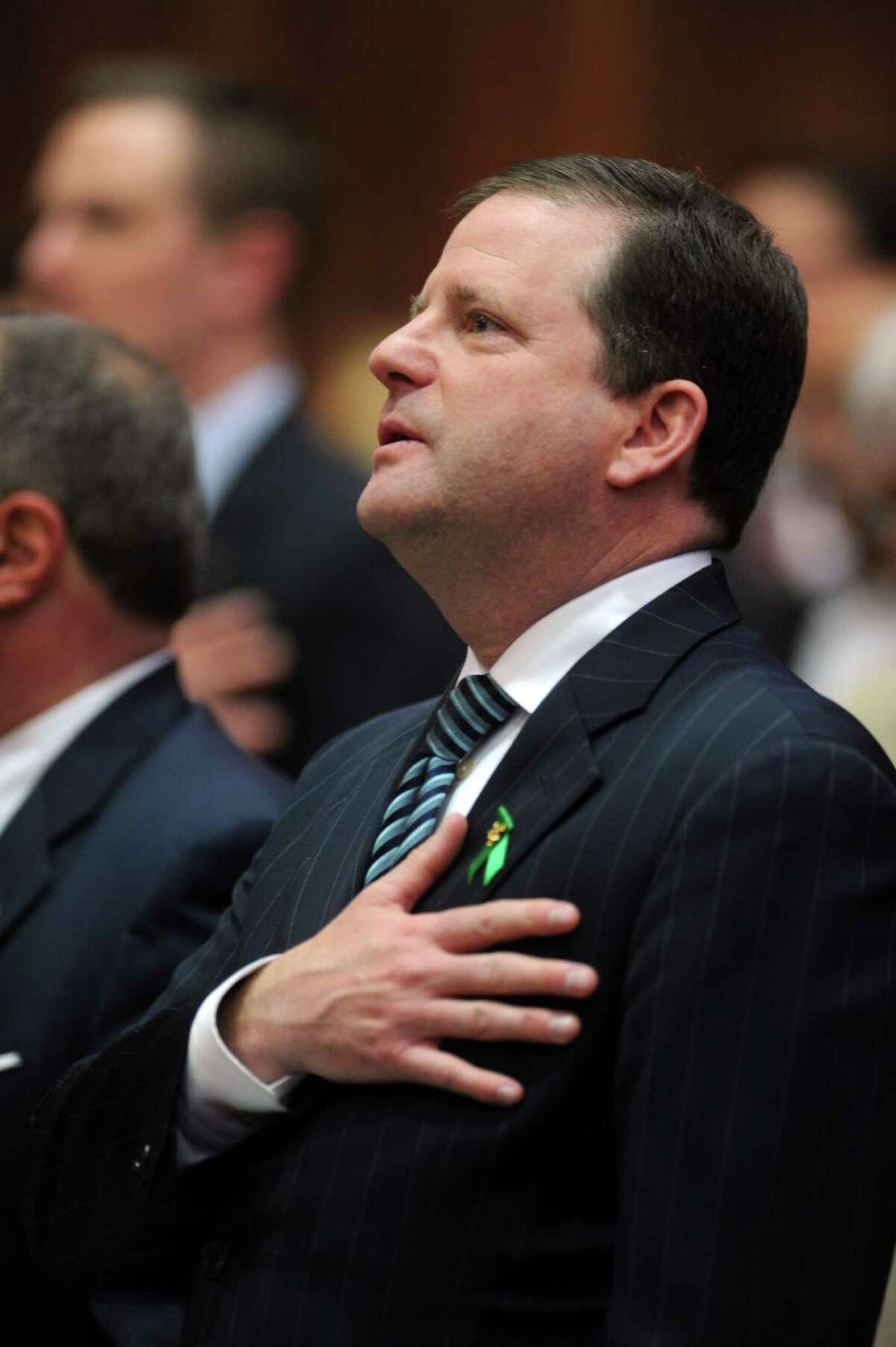 State Sen. John McKinney (R-Fairfield) stands for the Pledge of Allegiance Wednesday, Jan. 9, 2013 during opening day of the State Legislature at the Capitol Building in Hartford, Conn.