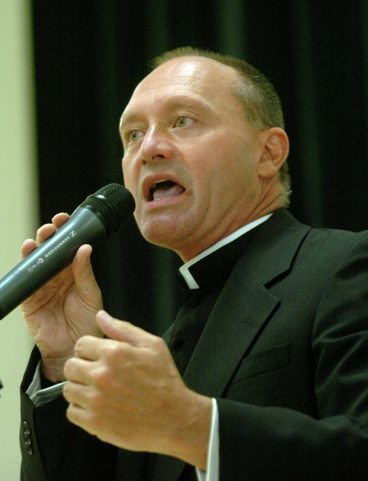 Monsignor Kevin Wallin addresses the faithful at a packed house at the Catholic Center on Jewett Avenue in Bridgeport, May 4, 2006.